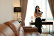 © Parichat - Young woman reading a book enjoying leisure time at home