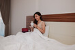 © Parichat - Young woman enjoying morning coffee in comfortable bed
