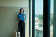© Parichat - Woman holding passport and smartphone, preparing for travel