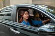 © Parichat - Young Asian woman driving car and smiling
