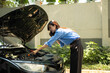 © Parichat - Woman experiencing car trouble making a phone call