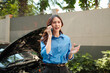 © Parichat - Woman making phone call for car breakdown assistance