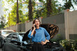 © Parichat - Woman calling for help with broken down car