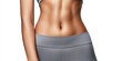 © NovaVision - Close-up of a fit woman's toned abdomen and athletic wear against a white background