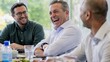 © siti - Cheerful Diverse Businessmen Laughing Together During Casual Lunch Meeting at Office