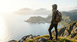 © Jai Izzam - Young traveler looking at coastal landscape from mountain peak