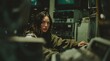 © Evarelle - Young woman in a dark room with vintage monitors and electronic equipment. Retro technology and hacker concept. Moody portrait with glowing screens