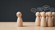 © Nida - Sad wooden figure excluded from group. Concept of bullying, discrimination, isolation, loneliness, and mental health in society, workplace or school.