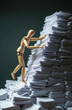 © miss irine - Wooden mannequin climbs giant stack of white paper documents. Concept shows hard work, office overload, and climbing corporate ladder. Effort and struggle against massive administration.