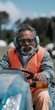 © Andrii Zastrozhnov - Bearded man driving tractor wearing safety vest in field