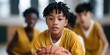 © Andrii Zastrozhnov - Young boy holding basketball in indoor gymnasium practice session