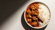 © Phetthanousack - Succulent chunks of slow-cooked goat meat simmered in a rich, aromatic curry sauce, served alongside fluffy white rice in a ceramic bowl, steaming, bowl, lunch