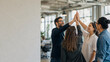 © Sukifli Dakheng - Happy business team giving high five for success