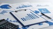 © Md - Blue bar chart on clipboard with calculator and pen on business documents finance statistics