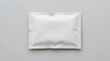© BazCam - A white rectangular package lies on a gray surface indoors.
