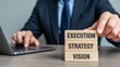 © Stock by Anika - Business strategy and management concept with wooden blocks showing vision, strategy and execution