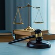 © Ryzhkov - Scale of justice and wooden books on a blue desk for professional legal banner, attorney office decor and judicial law firm advertising with soft window light