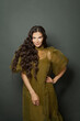 © millaf (Nemchinova) - Cheerful brunette woman with long healthy hair on dark background