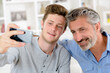 © auremar - son and father during smartphone conversation