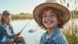 © Sergey - Young Boy Smile in Straw Hat by Lake as Older Brother Fishes Beside Him