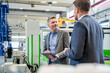 © Westend61 - Managers discuss organization with tablet in production hall