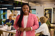 © Rido - Portrait of smiling black curvy businesswoman looking at camera