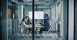 © Gorodenkoff - Business Team Meets in a Glass Conference Room to Review Digital Dashboards, Discuss Performance Metrics, Align Strategy, and Plan Key Projects, Focusing on Revenue Growth, Customer Results
