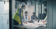 © Gorodenkoff - Executives and Engineers Meet in a Glass Conference Room to Review Construction Plans, Align Budget and Schedule, Track Progress on Laptops, and Coordinate Risk Control, Resource Allocation