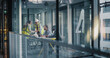 © Gorodenkoff - Executives and Engineers Meet in a Glass Office to Plan Construction Work, Review Digital Reports, Align Schedule and Budget, and Coordinate Safety, Quality Control, Resource Use, and Communication
