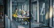 © Gorodenkoff - Executives and Engineers Meet in a Glass Office to Plan a Construction Project, Review Drawings and Reports, Align Schedule and Budget, Discuss Safety and Quality