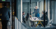 © Gorodenkoff - Businesswoman Leads a Strategic Planning Meeting in a Glass Conference Room, Explaining Goals, Reviewing Performance Metrics, Coordinating Tasks, and Encouraging Collaboration as Colleagues Listen