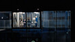 © Gorodenkoff - Night Office Meeting Shows a Female Manager Leading Three Coworkers Through a Clear Strategy Review, Using a Laptop, Charts, and Notes to Set Goals, Refine Plans, and Coordinate Upcoming Projects
