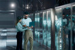 © Rendara Studio - 3D data center teamwork with laptop by mirrored server rack