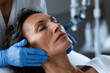 © Milos - An expert applies a treatment to a woman’s face, highlighting the delicate nature of skincare and the importance of professional care in achieving beauty goals and emotional well-being.