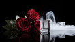 © muhamadhasan - Luxury perfume bottle with red roses and white fabric on black background.