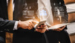 © InfiniteFlow - Two business professionals collaborate using a smartphone and tablet, surrounded by digital graphics representing teamwork and data in a modern work environment. Cyphers