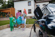 © Halfpoint - Happy family leaving home for summer vacation with luggage and pool toys.