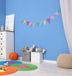 © New Africa - Child's room with colorful flags, toys and chest of drawers. Interior design