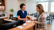 © Leo - Nurse handing patient paperwork at medical office reception