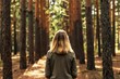 © Viktor - Woman walks through sunlit pine forest. She breathes fresh air, connects with nature, and finds inner peace. This scene promotes forest bathing and mindfulness.