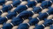 © Husein - Close up of woven blue and beige fabric texture with detailed pattern