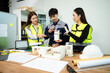 © Nuttapong punna - Three Asian architects discussing building model and blueprint. Architecture design, construction planning, teamwork and project management