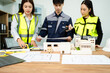 © Nuttapong punna - Three Asian architects discussing building model and blueprint. Architecture design, construction planning, teamwork and project management
