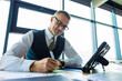 © be free - Businessman using tablet in business office. Freelancer working online. Man boss at working place, modern office. Businessman with tablet in office. Corporate online working. Business success