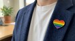 © White Craft  - Professional wearing rainbow heart pin on smart casual navy blazer close-up