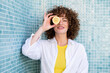 © VISTA by Westend61 - Model holding lemon slice over eye in empty pool