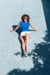 © VISTA by Westend61 - Smiling female tourist in sunglasses sitting in empty pool