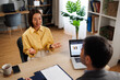 © djile - Female applicant discussing with interviewer during job interview