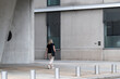 © yaqui_villegas - Solitude follows pedestrian on HafenCity walkway in Hamburg where modern architecture facade and minimalism shape an urban waterfront mood