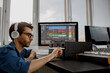 © Vlad - Male music arranger works with sound amplifier he is composing song on midi piano and audio equipment in digital recording studio. DJ in broadcasting studio. music, technology and equipment concept.